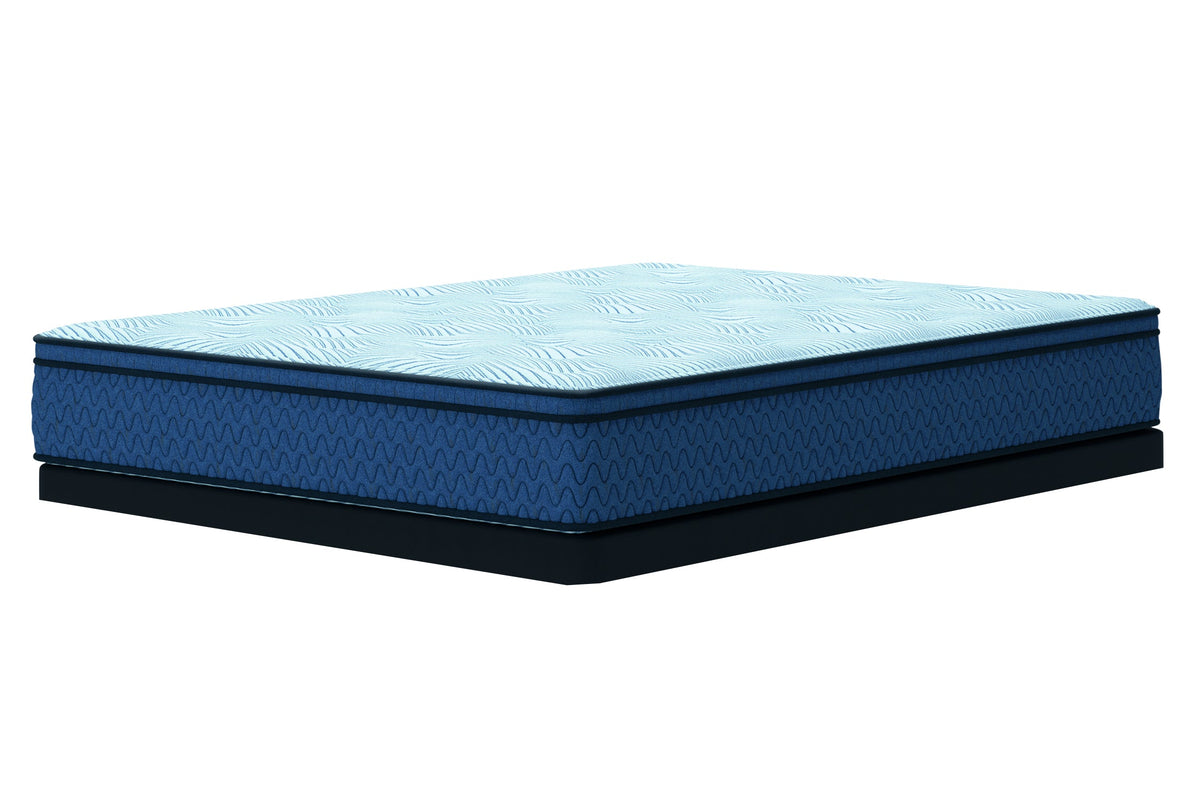 Queen hybrid mattress, light blue quilted top, royal blue wave-pattern sides, black low-profile foundation.